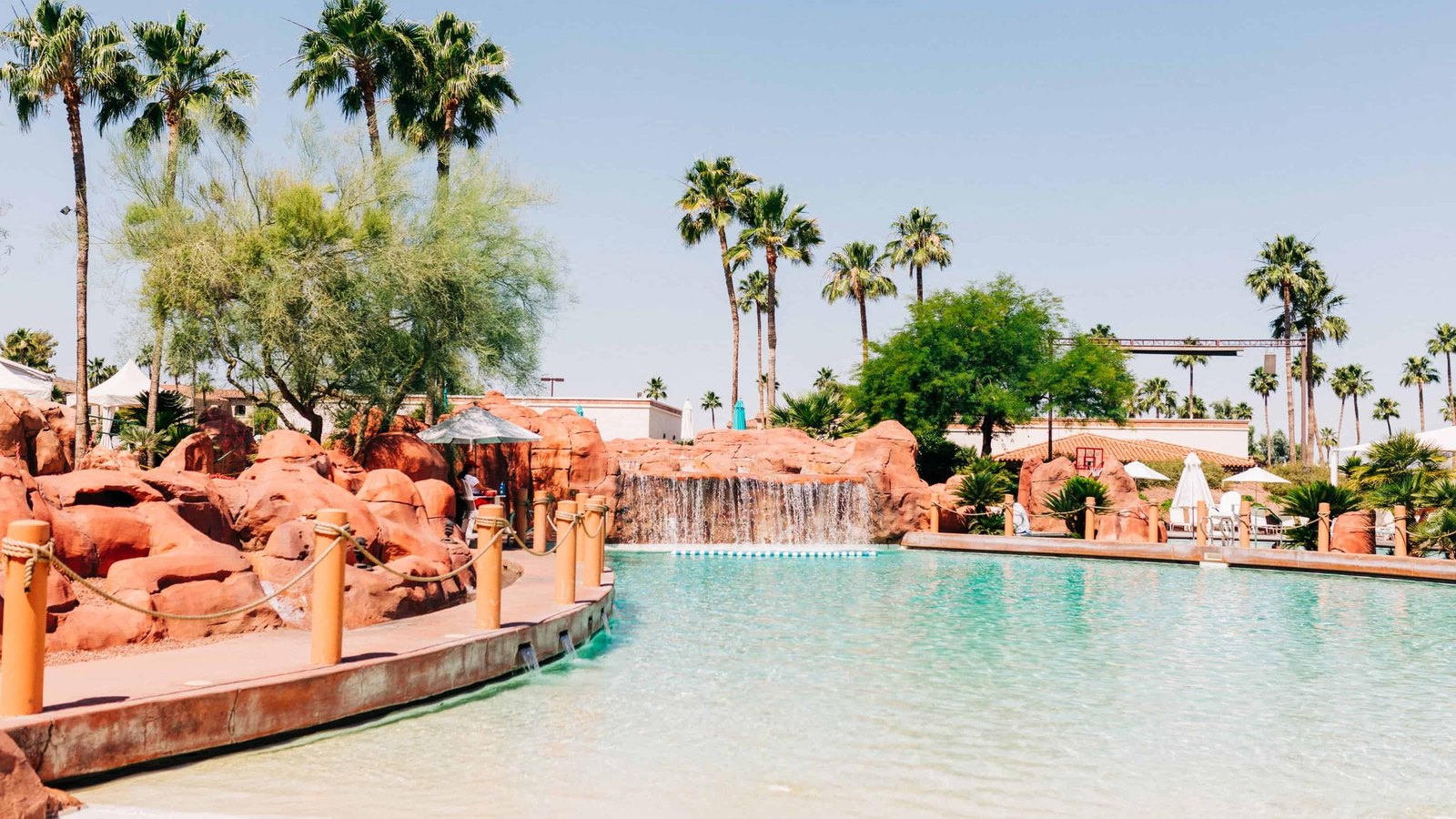 Lazy river with waterfall and palms